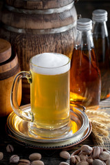 Light beer in a glass, on an old background.