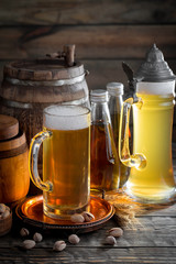 Light frothing beer in a glass, on an old background.