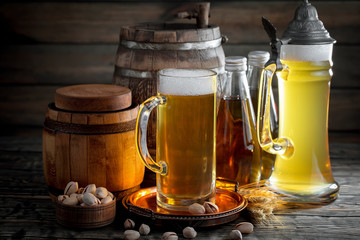 Light beer in a glass on a table in composition with accessories on an old background