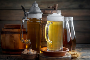 Light beer in a glass, on an old background.