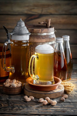 Light beer in a glass on a table in composition with accessories on an old background