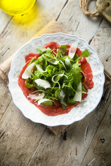 Beef carpaccio with arugula and Parmesan cheese