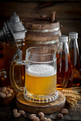 Light frothing beer in a glass, on an old background.