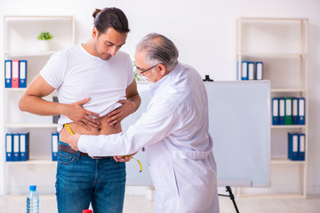 Doctor dietician giving advices to fat overweight patient