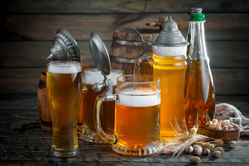 Light beer in a glass, on an old background.