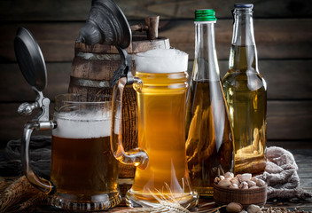 Light frothing beer in a glass, on an old background.