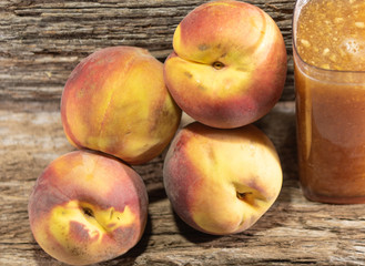 Naklejka na ściany i meble Glass of peach juice (Prunus persica L.) and fresh fruit
