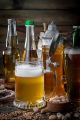 Light beer in a glass on a table in composition with accessories on an old background