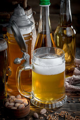 Light frothing beer in a glass, on an old background.