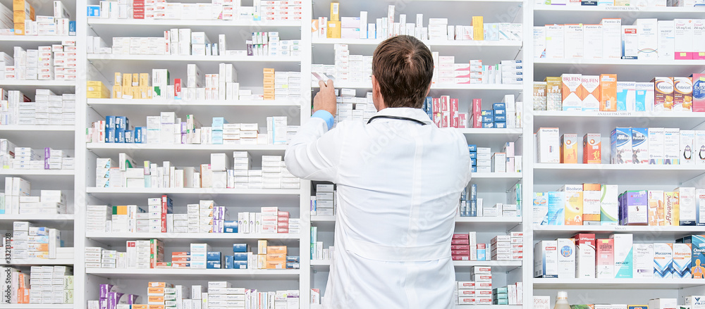 Wall mural pharmacist working in a drugstore