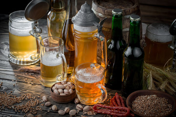 Light beer in a glass on a table in composition with accessories on an old background