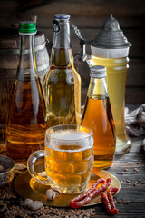 Light beer in a glass, on an old background.