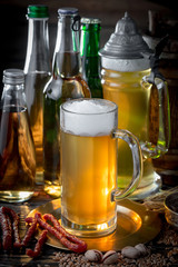 Light beer in a glass on a table in composition with accessories on an old background