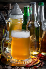 Light beer in a glass, on an old background.