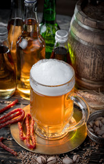 Light beer in a glass on a table in composition with accessories on an old background