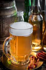 Light frothing beer in a glass, on an old background.