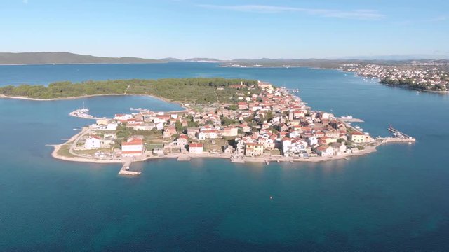 Drone fly over Krapanj little island of mediterranean See in Europe Croatia with a small town in a cloudy day of summer, travel destination