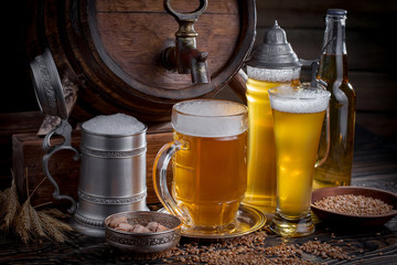 Light beer in a glass, on an old background.
