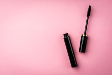 Mascara on pink background. Basic products for eyelashes makeup.