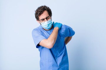 young man feeling tired, stressed, anxious, frustrated and depressed, suffering with back or neck...