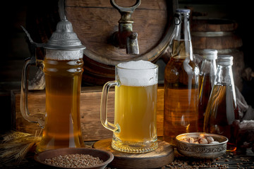 Light frothing beer in a glass, on an old background.