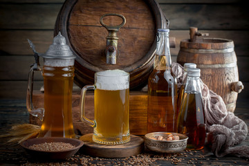 Light beer in a glass on a table in composition with accessories on an old background