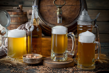 Light beer in a glass on a table in composition with accessories on an old background