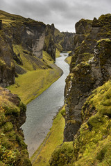 Deep green rocky valley with river
