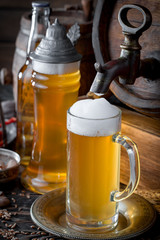 Light beer in a glass on a table in composition with accessories on an old background