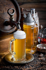 Light beer in a glass on a table in composition with accessories on an old background