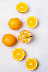 Glass of Tasty Orange Juice and Ripe Sliced Oranges Healthy Diet Detox Beverage Vitamin Light Gray Background Top View Vertical