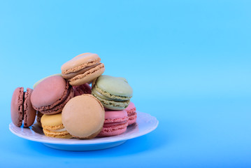 Colorful macaroons cake, sweet macaroon on blue background, food background