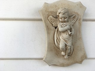 Little angel guardian plaque on a wall