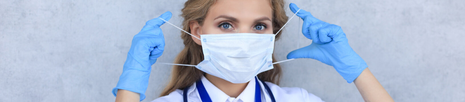 Medical staff preventive gear against coronavirus. Portrait of female doctor with stethoscope in mask.