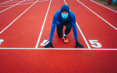 Runner wearing medical mask, Coronavirus pandemic Covid-19 in Europe. Sport, Active life in...