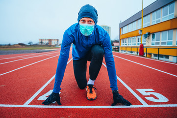 Runner wearing medical mask, Coronavirus pandemic Covid-19 in Europe. Sport, Active life in...
