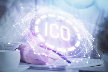 Cryptocurrency hologram over hands taking notes background. Concept of blockchain. Multi exposure