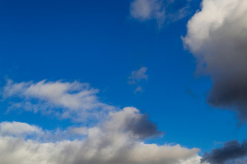 Bright white with grey clouds on blue sky. Beautiful background.