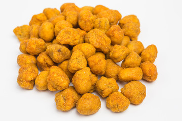 heap of roasted peanuts with paprika coating