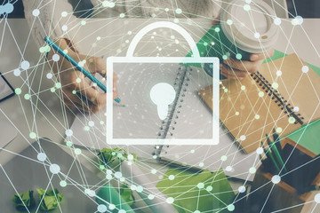 Double exposure of woman's hands writing with lock icon. Concept of security and protection of data
