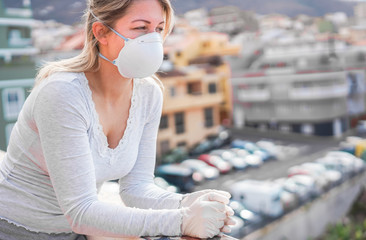 Young woman wearing face mask and gloves for coronavirus prevention - Stop spreading Covid 19 concept - Focus on hands