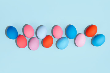Painted eggs on pastel background.