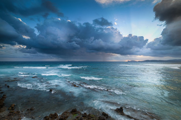 Dramatic sky over Alghero shore at sunset
