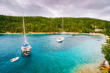 Foki beach near small town Fiskardo at Kefalonia, Ionian islands, Greece. Private yacht boats in the small lagoon