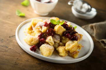 Traditional Austrian pancake dessert with cherry sauce