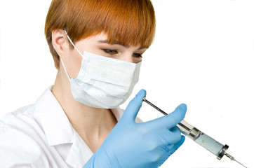 Young woman in white coat and gloves on a white background. Medicine, science, biology and chemistry concept