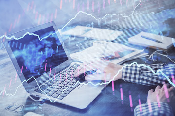Double exposure of forex chart with man working on computer on background. Concept of market analysis.