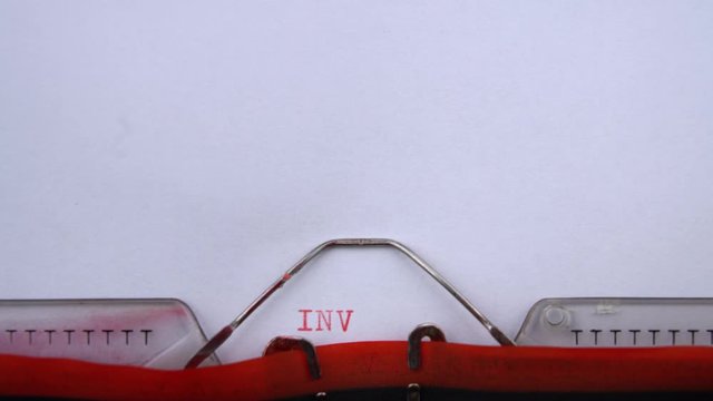 Investigation - word printed on an old typewriter in red letters, close up. vintage inscription