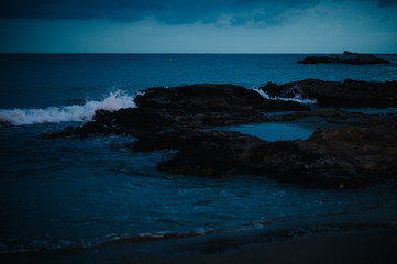 waves on the Mediterranean sea at night on the beach