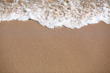 Abstract background of a sandy beach and sea foam with negative space